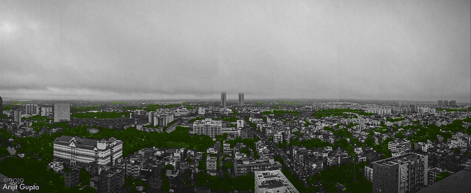 The cityscape of South Kolkata from the top of the Acropolis Mall in Kasba, showing the dense sprawling city with patches of greenery, and the suburban Kolkata in the distance. Photographed by Arijit Gupta in 2019.